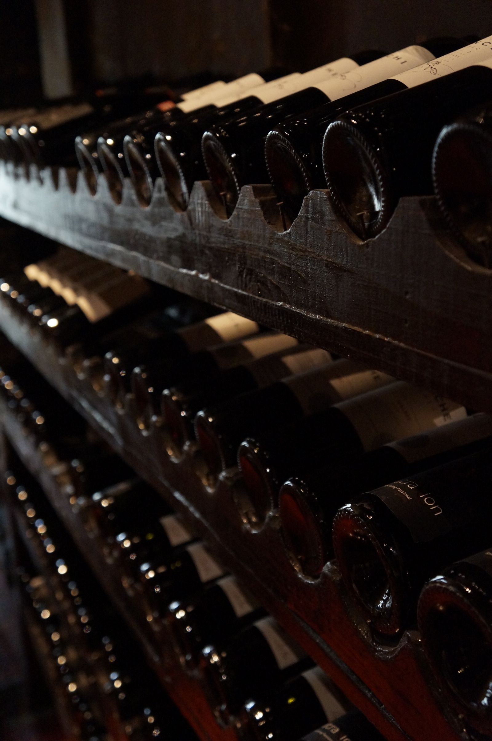 Wine bottles stored in cellar racks
